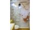 Accessible marble shower equipped with grab bars and a built-in wooden seat at 3359 Huffines Dr, Burlington, NC 27217