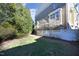Spacious backyard with lush lawn, manicured trees, and flowering trees near the home's exterior at 3937 Bentley Brook Dr, Raleigh, NC 27612