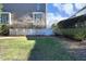 Large backyard with green lawn, mature trees, and a brick house exterior and white fence visible at 3937 Bentley Brook Dr, Raleigh, NC 27612