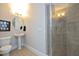 Bright bathroom featuring a glass shower, pedestal sink, and tile flooring at 3937 Bentley Brook Dr, Raleigh, NC 27612