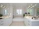 Bright bathroom with double vanity, soaking tub, and natural light from the window at 3937 Bentley Brook Dr, Raleigh, NC 27612