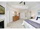 Bedroom showcasing the tray ceiling and a decorative fireplace with white mantle at 3937 Bentley Brook Dr, Raleigh, NC 27612