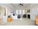 A bedroom with a tray ceiling includes a ceiling fan, fireplace, and access to the bathroom at 3937 Bentley Brook Dr, Raleigh, NC 27612