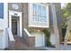 Charming brick townhouse featuring an attached two-car garage and landscaped entrance with a round window at 3937 Bentley Brook Dr, Raleigh, NC 27612