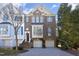 Charming brick townhome featuring a two-car garage and meticulously maintained landscaping, perfect for curb appeal at 3937 Bentley Brook Dr, Raleigh, NC 27612