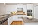 Well-equipped kitchen with stainless steel appliances, granite countertops, and white cabinetry at 3937 Bentley Brook Dr, Raleigh, NC 27612