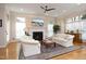 Bright living room features fireplace, ceiling fan and large windows providing natural light at 3937 Bentley Brook Dr, Raleigh, NC 27612