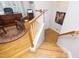 Hardwood staircase leading to the second floor with natural light and an open office at 3937 Bentley Brook Dr, Raleigh, NC 27612