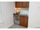 Elegant wet bar featuring wood cabinets, a sink, and a wine refrigerator for convenient entertaining at 3937 Bentley Brook Dr, Raleigh, NC 27612
