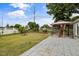 Manicured backyard featuring a well-maintained lawn, beautiful landscaping, a gazebo, and a privacy fence at 4002 Rothfield Ln, Raleigh, NC 27616