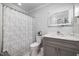 Charming bathroom with a patterned shower curtain and gray vanity at 4002 Rothfield Ln, Raleigh, NC 27616