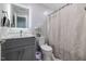 This bathroom features a modern vanity with a marble countertop and an illuminated mirror, along with a pristine toilet at 4002 Rothfield Ln, Raleigh, NC 27616