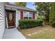 Inviting front entrance features a decorative door, well-kept bushes, and a 'Welcome' sign at 4002 Rothfield Ln, Raleigh, NC 27616