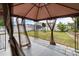 Cozy gazebo featuring sheer curtains overlooking a well-maintained lawn, providing a perfect outdoor escape at 4002 Rothfield Ln, Raleigh, NC 27616