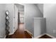 Upstairs hallway with hardwood floors leads to a room with a window at 4002 Rothfield Ln, Raleigh, NC 27616