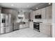 Beautiful kitchen featuring stainless steel appliances and stylish gray cabinetry at 4002 Rothfield Ln, Raleigh, NC 27616