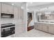 Bright eat-in kitchen showcases gray cabinets, stainless appliances, tile floors, and pendant lights at 4002 Rothfield Ln, Raleigh, NC 27616