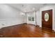 Staged living room boasting hardwood floors, wainscoting, and an elegant chandelier at 4002 Rothfield Ln, Raleigh, NC 27616