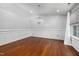 Spacious living room featuring hardwood floors, wainscoting, and an elegant chandelier at 4002 Rothfield Ln, Raleigh, NC 27616