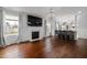 Open-concept living area featuring hardwood floors, fireplace, and chandeliers at 4002 Rothfield Ln, Raleigh, NC 27616
