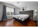 Bright main bedroom features hardwood floors, vaulted ceilings, and large windows at 4002 Rothfield Ln, Raleigh, NC 27616