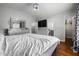 Spacious bedroom with hardwood floors, vaulted ceilings, closet, and ensuite bathroom at 4002 Rothfield Ln, Raleigh, NC 27616