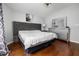 Bright main bedroom features hardwood floors, vaulted ceilings, and stylish furnishings at 4002 Rothfield Ln, Raleigh, NC 27616