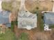 Wide aerial shot displays the property layout and surrounding landscape with a backyard patio at 401 Acorn Falls Ct, Holly Springs, NC 27540