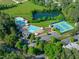 Aerial view of community amenities, including a pool, tennis courts, and pond at 401 Acorn Falls Ct, Holly Springs, NC 27540