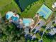 Community aerial view featuring a swimming pool, tennis court, and lake at 401 Acorn Falls Ct, Holly Springs, NC 27540