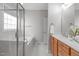 Bright bathroom featuring a glass shower, soaking tub, wood vanity and tile flooring at 401 Acorn Falls Ct, Holly Springs, NC 27540