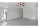 This spacious bedroom features gray carpet, a door to the backyard and a ceiling fan at 401 Acorn Falls Ct, Holly Springs, NC 27540