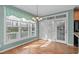 Breakfast nook with hardwood flooring, large window and glass panel doors leading to the outside at 401 Acorn Falls Ct, Holly Springs, NC 27540
