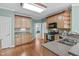 Well-lit kitchen featuring wood cabinetry, stainless steel appliances, and granite counters at 401 Acorn Falls Ct, Holly Springs, NC 27540
