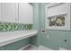 This laundry room has lots of storage and a tropical backsplash for some added flair at 401 Acorn Falls Ct, Holly Springs, NC 27540