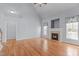 Bright living room featuring wood flooring, fireplace, and a doorway that leads to another room at 401 Acorn Falls Ct, Holly Springs, NC 27540