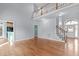 Open-concept living space with fireplace, wood flooring and views of the foyer and staircase at 401 Acorn Falls Ct, Holly Springs, NC 27540