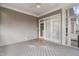 Covered porch with white wood floor and railing offers outdoor access and partial shade. A rug sits by the door at 401 Acorn Falls Ct, Holly Springs, NC 27540
