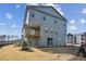 Three-story home with a deck overlooking the yard and a partial fence line at 4724 Cypress Tree Ln, Raleigh, NC 27612