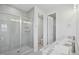 Modern bathroom with double sinks, a glass shower, and neutral color palette at 4724 Cypress Tree Ln, Raleigh, NC 27612