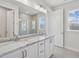 Bright bathroom with double vanity, granite countertops, and a glass-enclosed shower at 4724 Cypress Tree Ln, Raleigh, NC 27612