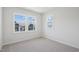 Bright bedroom featuring plush carpet and large windows with views of the community at 4724 Cypress Tree Ln, Raleigh, NC 27612