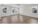 Spacious bedroom featuring hardwood floors, natural lighting, and a ceiling fan at 4724 Cypress Tree Ln, Raleigh, NC 27612