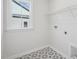 Clean and functional laundry room with patterned floors and built-in shelving at 4724 Cypress Tree Ln, Raleigh, NC 27612