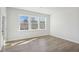 Inviting living room with wood floors and large windows overlooking scenic outdoor views at 4724 Cypress Tree Ln, Raleigh, NC 27612