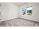 Cozy bedroom with neutral carpet and a large window overlooking the front yard at 4888 Pioneer Dr, Sanford, NC 27330