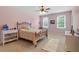 Bedroom with pink walls, carpet, two windows, and neutral furniture at 4917 Trotter Dr, Raleigh, NC 27603