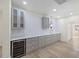 Stylish bar area featuring grey cabinets, marble countertops, a wine fridge, and modern pendant lighting at 512 S 4Th St, Smithfield, NC 27577