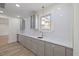 Elegant bar area showcasing grey cabinets, marble countertops, gold hardware, and stylish pendant lighting at 512 S 4Th St, Smithfield, NC 27577