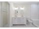 Bathroom featuring a double vanity, decorative mirrors and updated fixtures at 512 S 4Th St, Smithfield, NC 27577